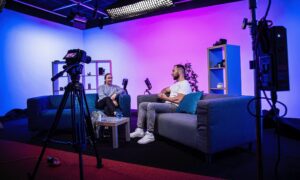 “Two hosts recording a podcast interview in Fluent Media’s Bromley video-podcast studio”